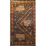 An Eastern hand-knotted wool rug with geometric decoration on blue and brown ground,