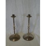 A pair of good quality beaten silver candlesticks with slender stems and circular bases,