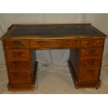 A 19th Century oak and pine rectangular pedestal desk with three drawers in the frieze and six