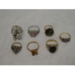 An 18ct gold dress ring set topaz, three various 9ct gold dress rings and others,