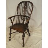 A 19th Century elm and ash Windsor armchair with shaped seat on turned tapered legs