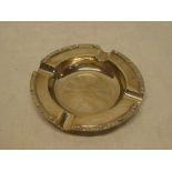 A good quality silver circular ash tray with decorated edge,