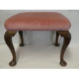 A modern Queen Anne-style rectangular walnut stool with upholstered rectangular seat on carved
