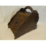 A 19th Century carved oak traditional coal box with hinged sloping front and mask head handle