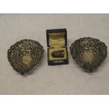 A pair of Edward VII silver heart-shaped sweetmeat dishes with raised and pierced decoration,