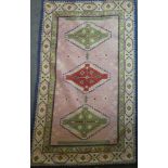 Two small Eastern-style rectangular wool rugs with geometric decoration