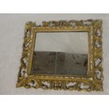 A small rectangular wall mirror in ornate gilt painted frame,