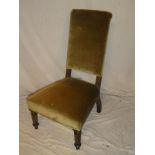 A 19th Century rosewood nursing chair with upholstered seat and back on turned legs