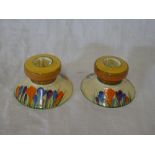 A pair of Clarice Cliff Bizarre "Crocus" pattern squat-shaped candlesticks,