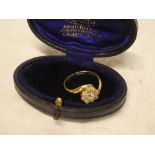 An 18ct gold engagement ring set diamond cluster