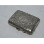 A George V silver rectangular concave cigarette case with engraved scroll decoration,