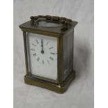 A Continental carriage clock with rectangular enamelled dial in brass traditional glazed case