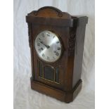 A 1920/30s mantel clock with silvered circular dial in oak glazed case