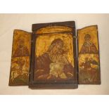 An old Greek copy icon with painted religious scenes and hinged front,