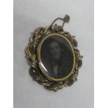 A Victorian pinchbeck oval mourning brooch with inset male bust portrait,