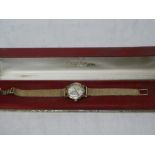 A ladies 9ct gold wristwatch by Omega "The Omega Ladymatic" with 9ct gold strap in original box