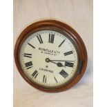 An old wall clock with painted circular dial by Russells Limited 18 Church Street Liverpool,