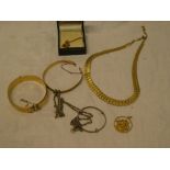A selection of various costume jewellery including two various gold plated bangles, necklace,