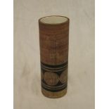 A Troika pottery cylindrical vase with geometric decoration on brown ground marked "Troika St Ives