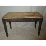 A 19th Century pine rectangular scrub top kitchen table with two drawers in the frieze on turned