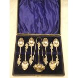 A set of six Edward VII silver tea spoons with matching sugar tongs and sifting ladel with scroll