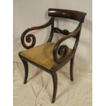 A 19th Century mahogany carver armchair with carved rail back and upholstered seat on sabre legs