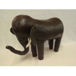 A rare Liberty & Co brown leather covered footstool in the form of an elephant,