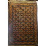 An Eastern-style wool rug with geometric decoration on orange and brown ground,