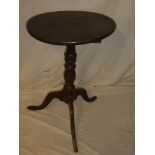 An 18th Century oak and elm circular snap top occasional table on turned column with tripod base