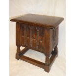A good quality carved oak rectangular stool with hinged lid and box seat on turned supports,