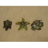 Three various silver and enamelled brooches including starfish,