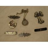 A selection of various old silver brooches including gold mounted examples, coin pendant,