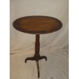 A 19th Century mahogany cross-banded oval occasional table on turned column tripod base