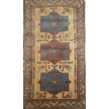 A good quality Eastern rectangular wool rug with geometric decoration on blue,