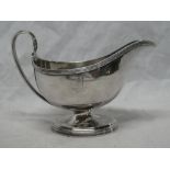 A George III silver classical-shaped pedestal sauce boat with loop handle on oval base,