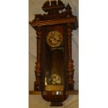 A Vienna-style wall clock with decorated circular dial in polished walnut glazed case