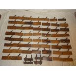 A collection of over 50 various old carpenter's beechwood moulding planes in varying designs and