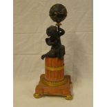 A 19th Century French bronze and gilt mantel clock in the form of a sphere held aloft by a bronze