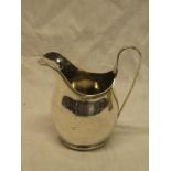A George V silver classical-shaped cream jug with loop handle,
