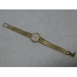 A ladies 9ct gold wristwatch by Longines with 9ct gold strap