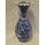 A Japanese pottery baluster shaped vase with blue and white landscape decoration,