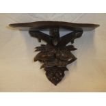 A Continental polished and carved wood wall bracket,