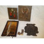 A copper mounted rectangular icon depicting religious figure and two other various icon-type panels