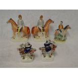 A pair of Victorian Staffordshire pottery figures of jockeys on horseback (af),