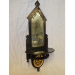 A late Victorian ebonised and gilt painted arched wall mirror with semi-circular shelf and