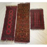 Two small Eastern wool runners with geometric decoration on red ground and one other smaller