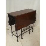 An ornate Edwardian mahogany rectangular drop leaf centre table with a drawer in one end on fine
