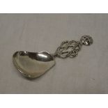 A George V silver caddy spoon with pierced and decorated handle,