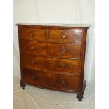 A large Victorian figured mahogany bow-front chest of two short and three long drawers with turned