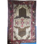 A good quality modern Eastern-style rectangular rug with geometric decoration on brown and red